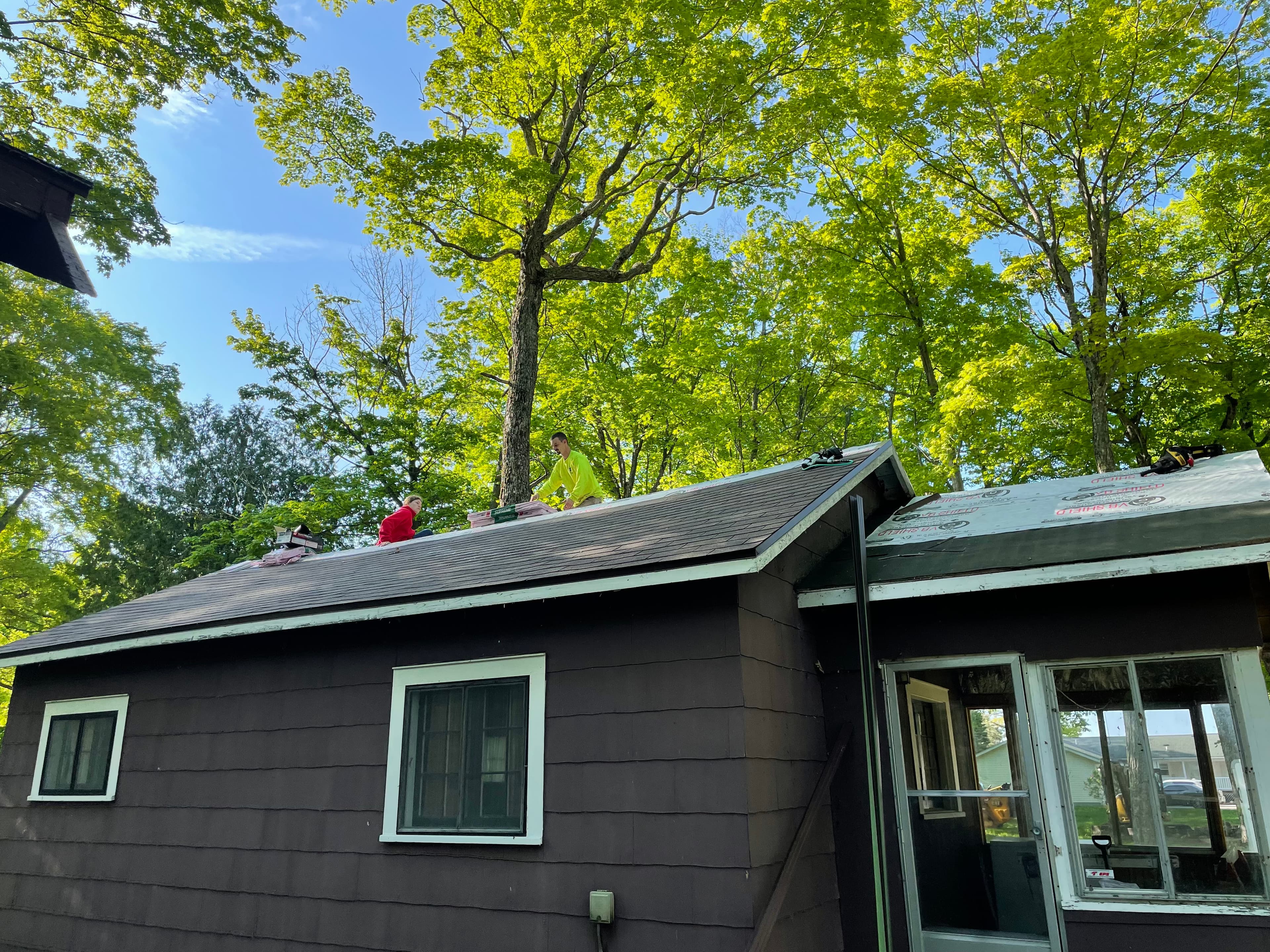 Crew shingling a residential roof