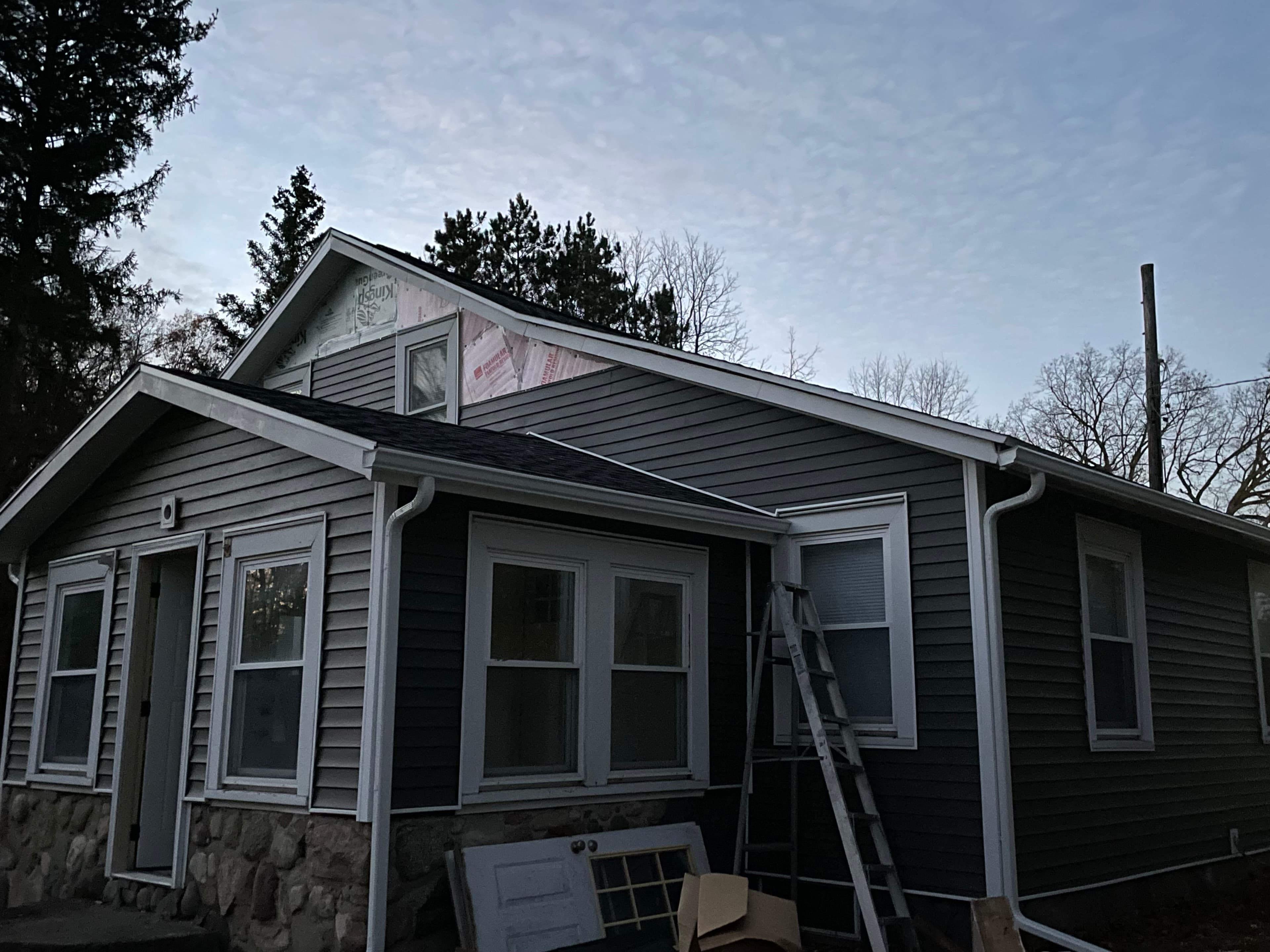 Full exterior with siding, gutters and roofing